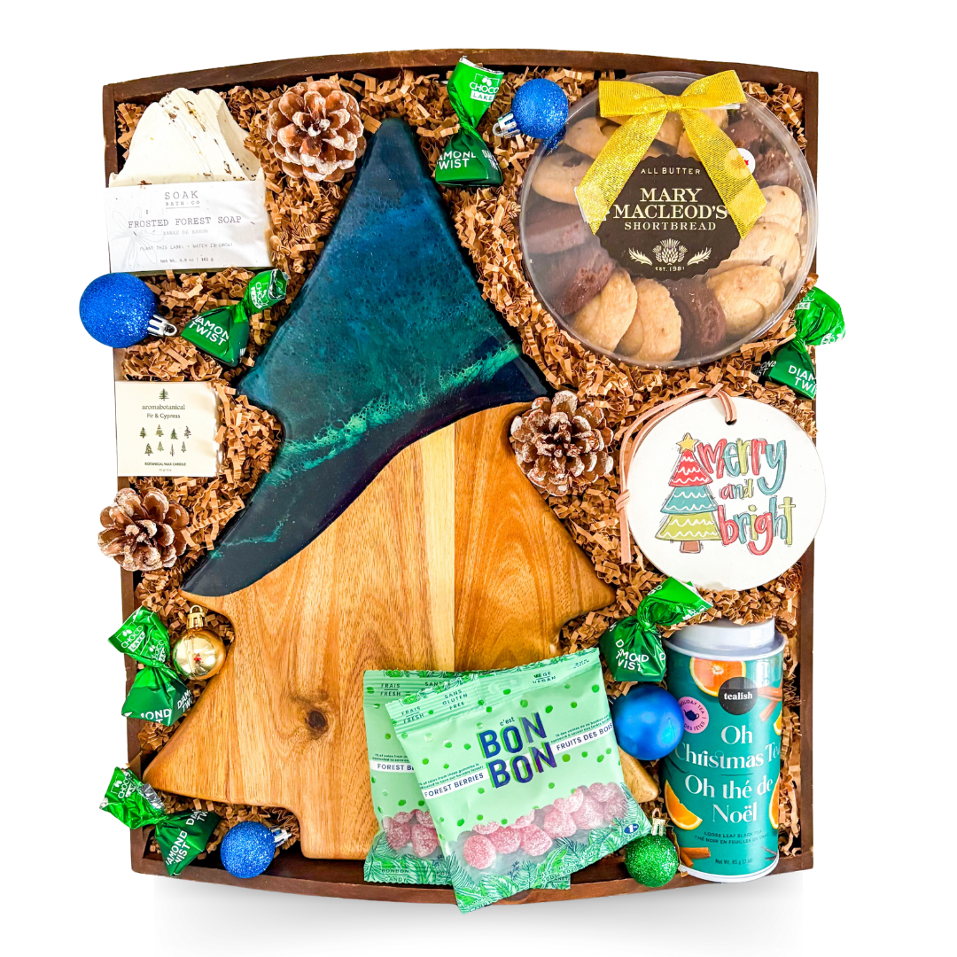 Holiday gift tray with an Aurora-inspired tree resin board and festive evergreen accents.
