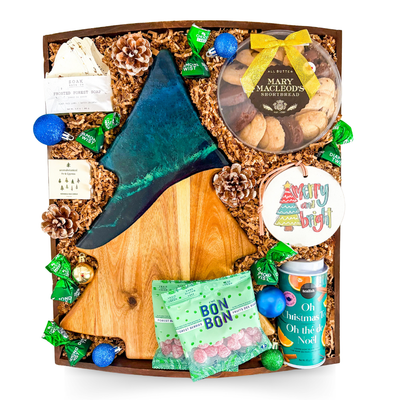 Holiday gift tray with an Aurora-inspired tree resin board and festive evergreen accents.