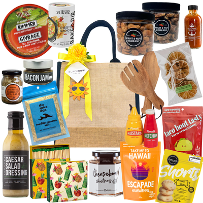 Patio Pantry gourmet summer gift tote with snacks, Caesar mix essentials, dips, seasonings, entertaining accessories, and savoury treats in a burlap tote.