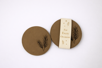 PU leather coaster featuring an engraved pine tree design and stitched edging for a clean, nature-inspired look.