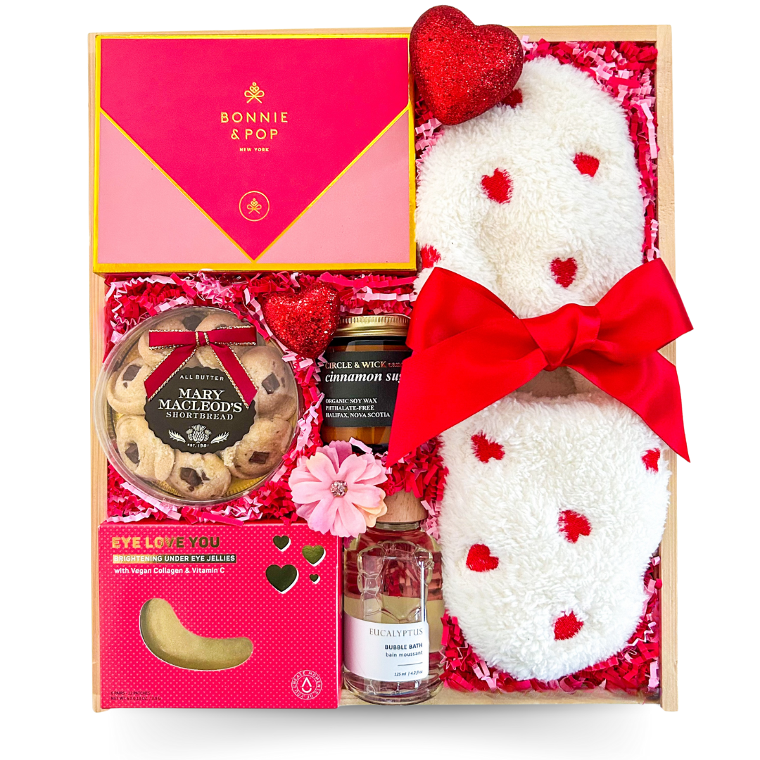 Valentine’s Day gift box, relaxation gift set, self-care package for her, romantic gift idea, Valentine’s Day pampering kit, chocolate and spa gift box, heart-themed Valentine’s gift, luxury self-care box, cozy slippers gift set, bubble bath and chocolate bundle, eye mask and relaxation set, Valentine’s Day spa box, indulgent gift box for her, Valentine’s chocolate gift set, heart slippers gift idea, romantic pampering gift, Valentine’s relaxation bundle, spa day at home gift, thoughtful Valentine’s gift 