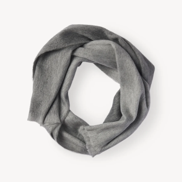 Soft natural alpaca scarf in a grey ombre design, styled in a loop to showcase its lightweight and cozy texture.