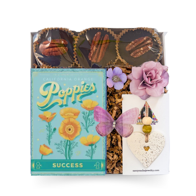 Seeds of Success celebration gift box with orange poppy seed pack, artisan chocolates and bright blue and yellow accents by Black Bow Gift Co.