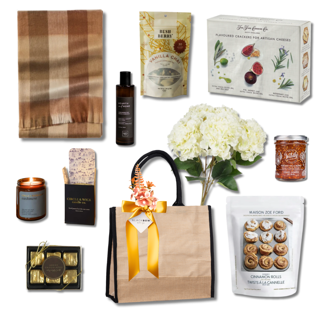 Settle In luxury housewarming gift basket with neutral throw blanket, candle, vanilla chai, gourmet crackers, preserves, chocolates and cinnamon rolls