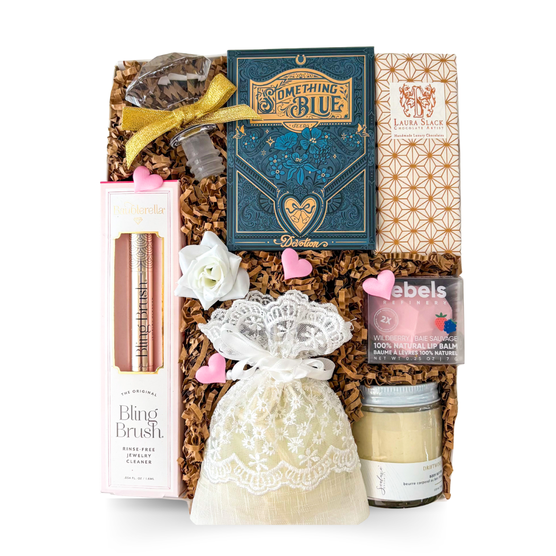 Bride to be gift box featuring a diamond ring bottle opener, jewelry cleaner, pearl scrunchie in a keepsake pouch, body butter, lip balm and artisan chocolate by Black Bow Gift Co.

