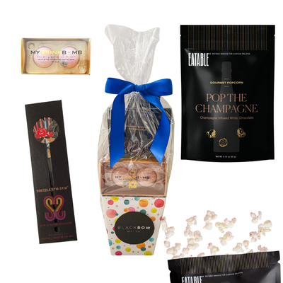 Birthday gift featuring cocktail bombs, decorative cocktail stir stick, birthday cake popcorn, and festive presentation in a colorful birthday gift box by Black Bow Gift Co.