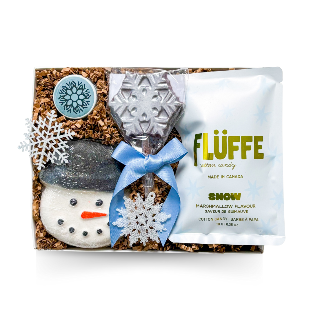 Small winter gift box with snowy themed treats and cozy seasonal accents.
