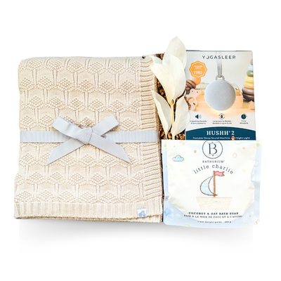 Soft Beginnings luxury baby gift with cream blanket, white onesie, sound machine, and gentle bath items