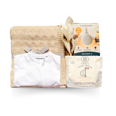 Soft Beginnings luxury baby gift with cream blanket, white onesie, sound machine, and gentle bath items