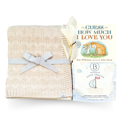 Soft Beginnings luxury baby gift with cream blanket, white onesie, sound machine, and gentle bath items