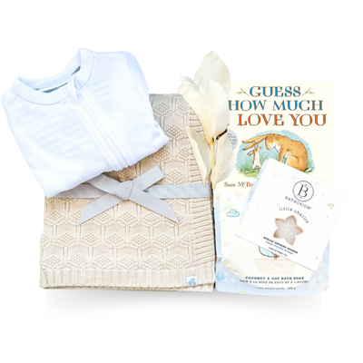 Soft Beginnings luxury baby gift with cream blanket, white onesie, sound machine, and gentle bath items