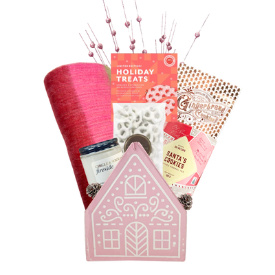 Sugarplum Wishes Christmas gift basket featuring a soft pink scarf, gourmet chocolates, festive sweets and candle in a blush pink gingerbread cottage keepsake.
