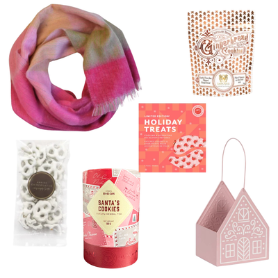Sugarplum Wishes Christmas gift basket featuring a soft pink scarf, gourmet chocolates, festive sweets and candle in a blush pink gingerbread cottage keepsake.