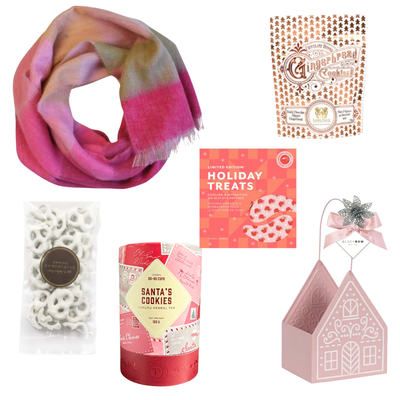 Sugarplum Wishes Christmas gift basket featuring a soft pink scarf, gourmet chocolates, festive sweets and candle in a blush pink gingerbread cottage keepsake.