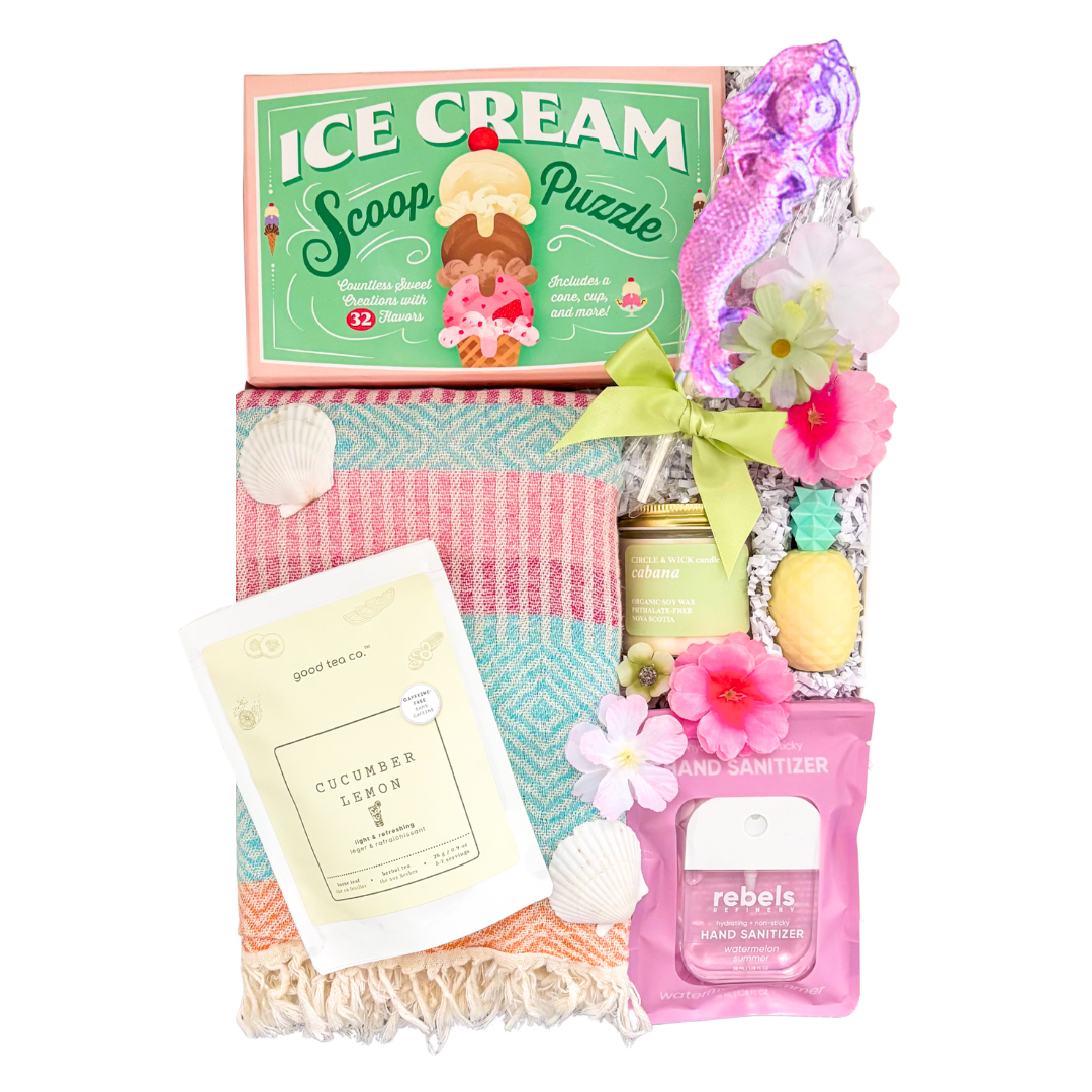 Summer Fun gift box featuring a Turkish towel, puzzle, candle, tea, pineapple lip balm, lollipop, and sweet treats by Black Bow Gift Co.

