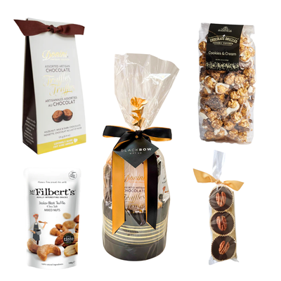 Gourmet chocolate gift basket featuring artisan chocolate truffles, handcrafted chocolate pecan clusters, cookies and cream popcorn, gourmet roasted nuts, and premium sweet treats, beautifully wrapped for gifting.