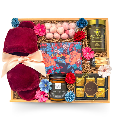 Sweet Escape feminine relaxation gift featuring cozy comforts, chocolates, candle and playing cards in a wooden tray.
