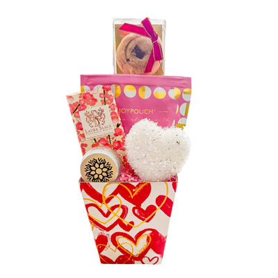 Sweet Valentine’s gift featuring shortbread cookies, milk chocolate bar, hot cross bun fudge, and vanilla lip balm in soft pink tones.