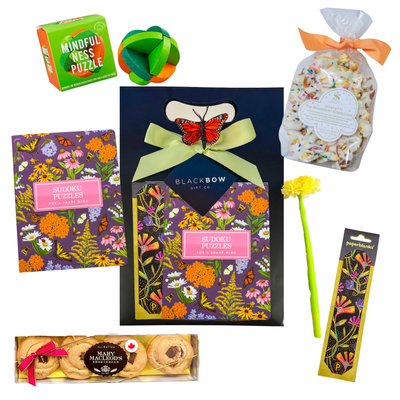 Self-care gift with snacks, puzzles, sudoku book, popcorn, pen, and bookmark for relaxing and mindful breaks.