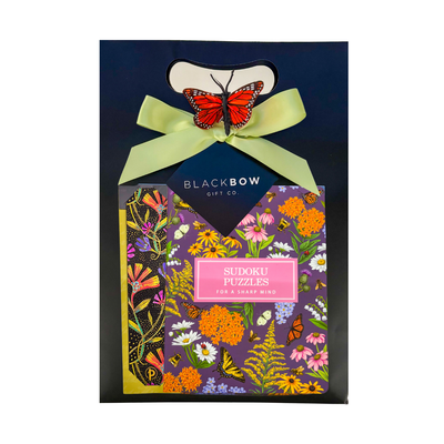 Self-care gift with snacks, puzzles, sudoku book, popcorn, pen, and bookmark for relaxing and mindful breaks.