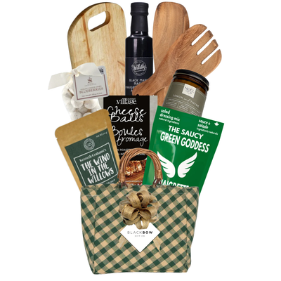 The Culinary Collection gourmet gift basket featuring a wooden serving board, salad utensils, artisan culinary essentials and gourmet treats in a forest green gingham keepsake basket.