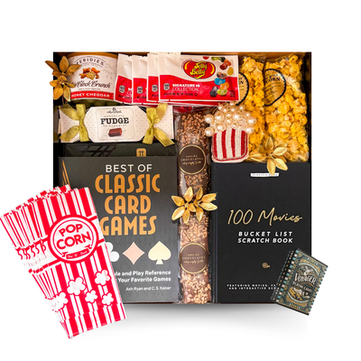The Perfect Night In movie gift box featuring 100 Movies Bucket List scratch book, gourmet popcorn, chocolates, fudge, candy, movie snacks and festive accents.