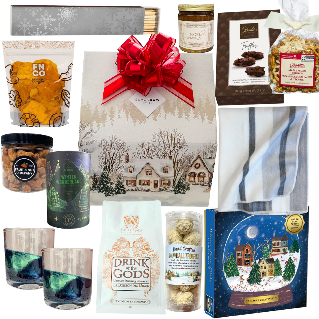 The Winter Escape luxury gift featuring a cozy blanket, elegant drinkware, gourmet chocolates, hot chocolate and artisan treats in a beautifully illustrated winter village gift package.