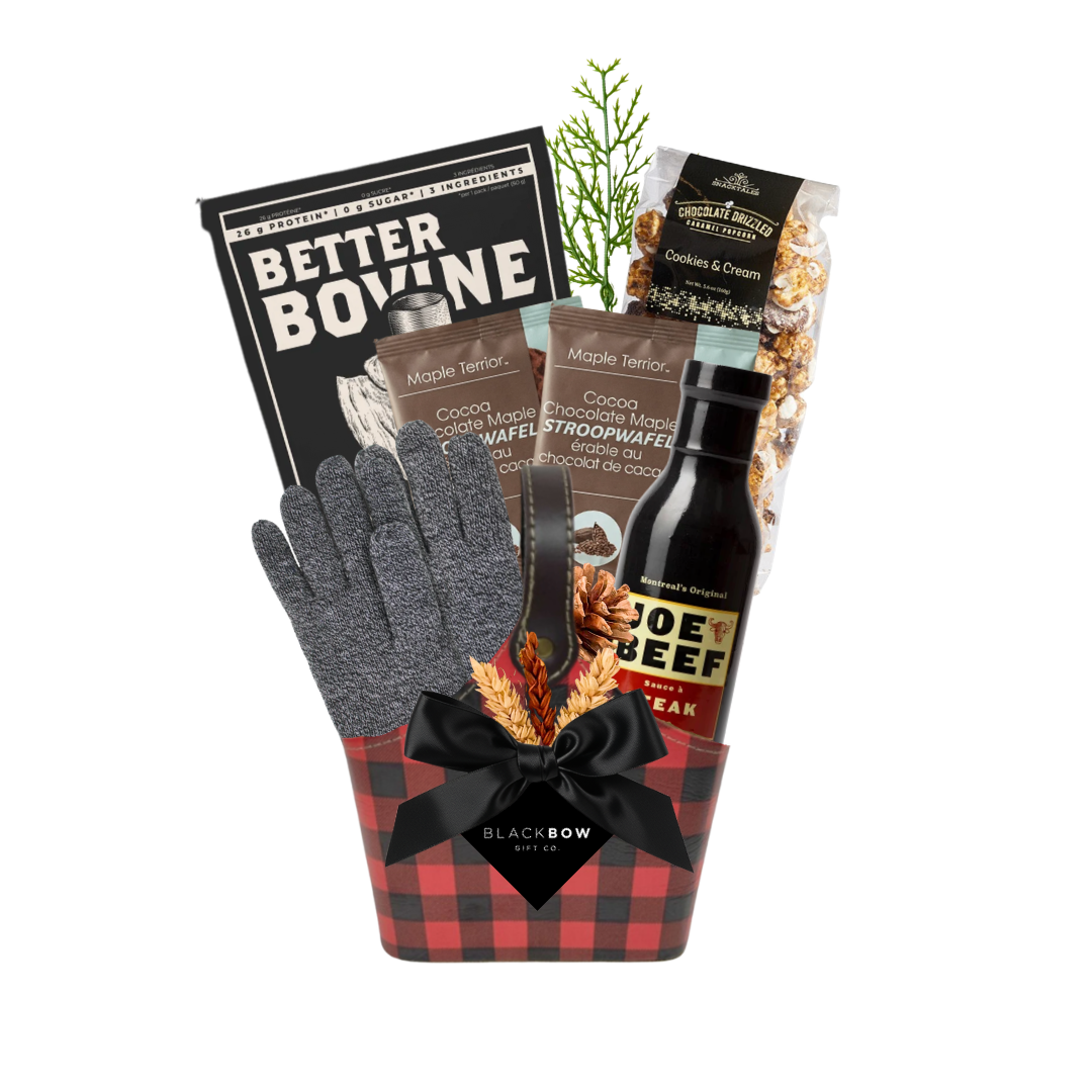 The Winter Explorer gift basket featuring a red and black buffalo plaid keepsake caddy filled with gourmet snacks, winter accessories and cozy wool gloves with an optional sock selection.