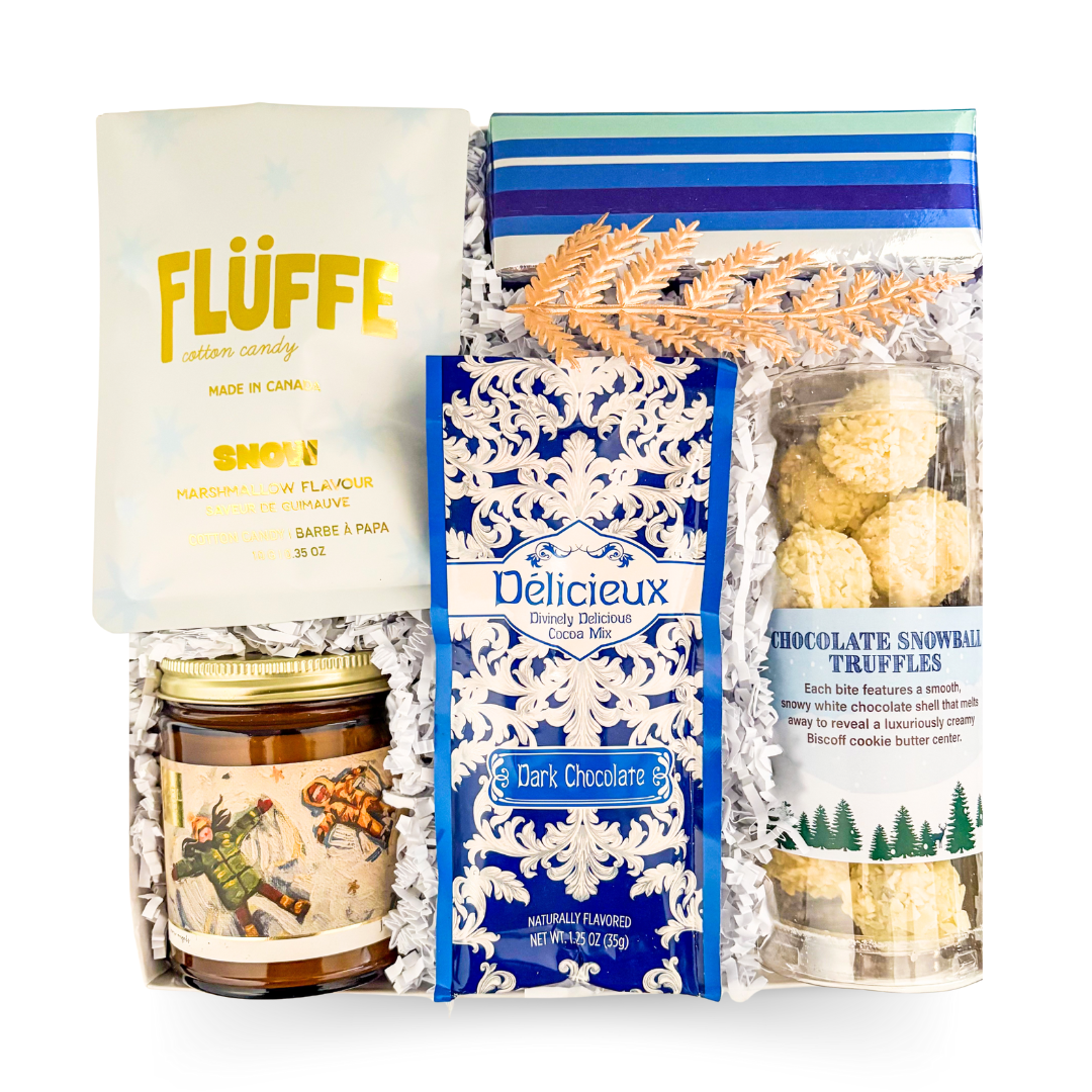 Cozy winter gift with assorted chocolates and a candle, styled for relaxed evenings and sweet indulgence.