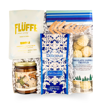 Cozy winter gift with assorted chocolates and a candle, styled for relaxed evenings and sweet indulgence.