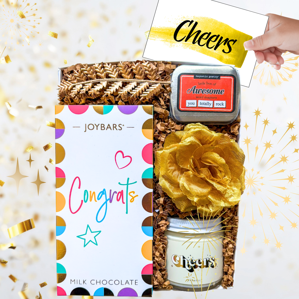 The Congrats Box with vibrant chocolate bar, word magnets, and a candle or seed pack styled as a bright, modern celebration gift.
