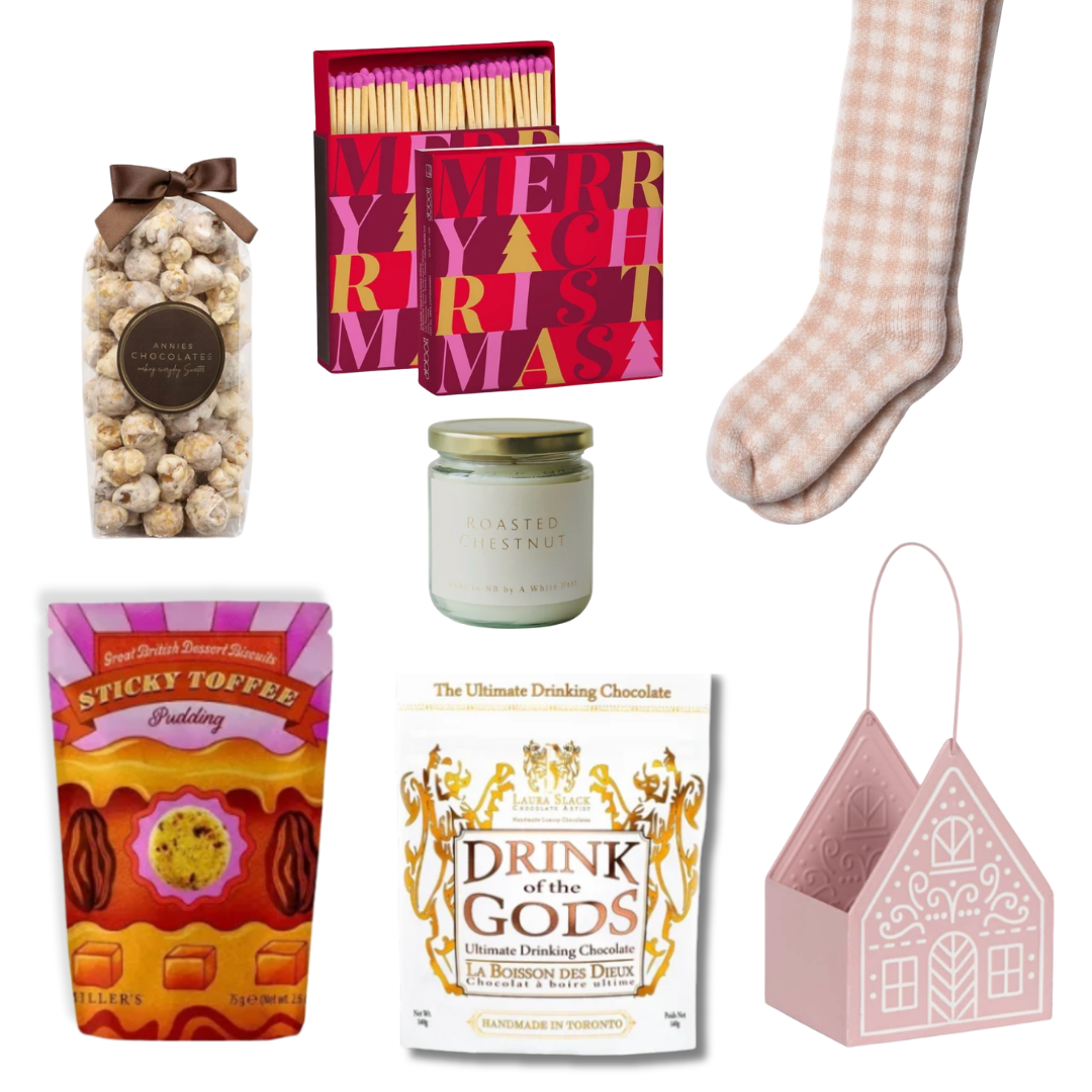The Cozy Cottage gift basket featuring blush pink reading socks, roasted chestnut candle, gourmet chocolates, sweet treats and a pink cottage keepsake basket.