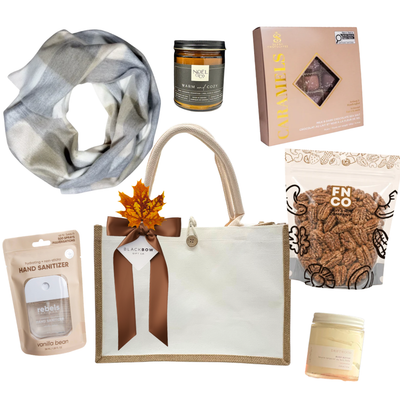 The Cozy Edit gift with reusable canvas bag, stylish scarf, candle, body care, chocolates and maple cinnamon pecans.