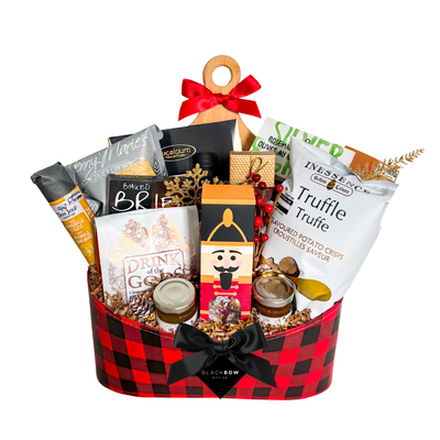 The Festive Spread Christmas gourmet gift basket in red and black buffalo plaid with truffle crisps, crackers, preserves, festive drink mix and chocolates.