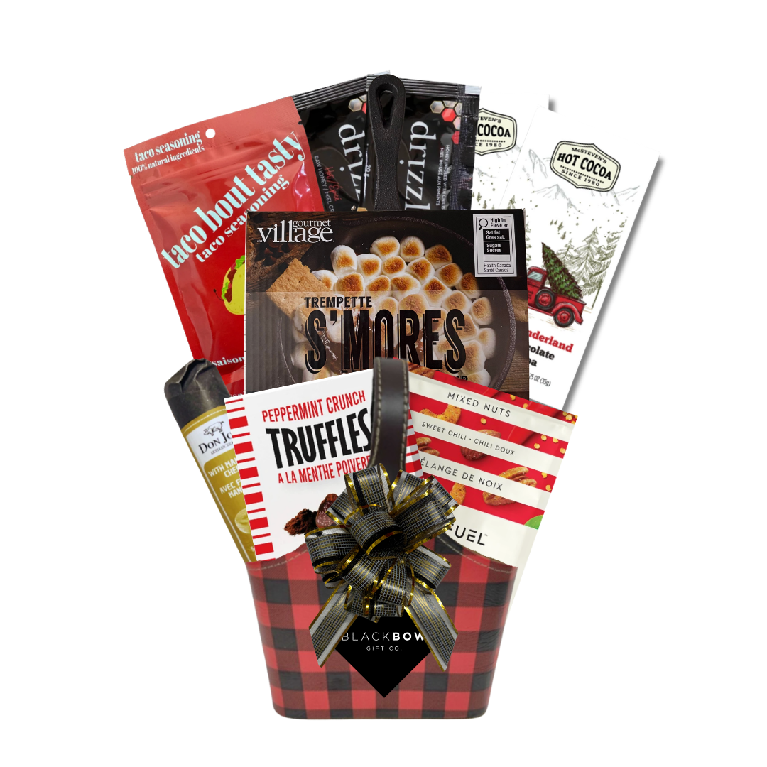 The Great Indoors gourmet gift basket featuring hot chocolate, peppermint truffles, gourmet nuts and savoury snacks in a red and black buffalo plaid keepsake basket.