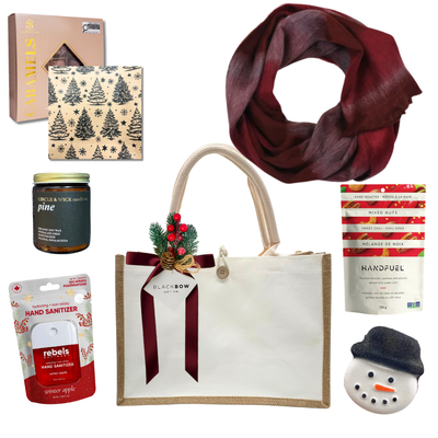 The Holiday Embrace Christmas gift featuring a burgundy scarf, pine-scented candle, gourmet chocolates, festive nuts, holiday treats and an elegant reusable tote.