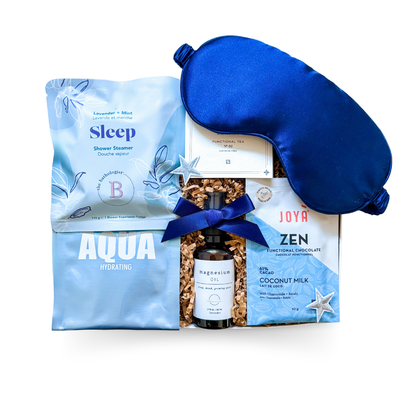 The Sleep Kit gift box with navy and white starry design, luxe sleep accessories, calming tea, and relaxation-inspired treats.