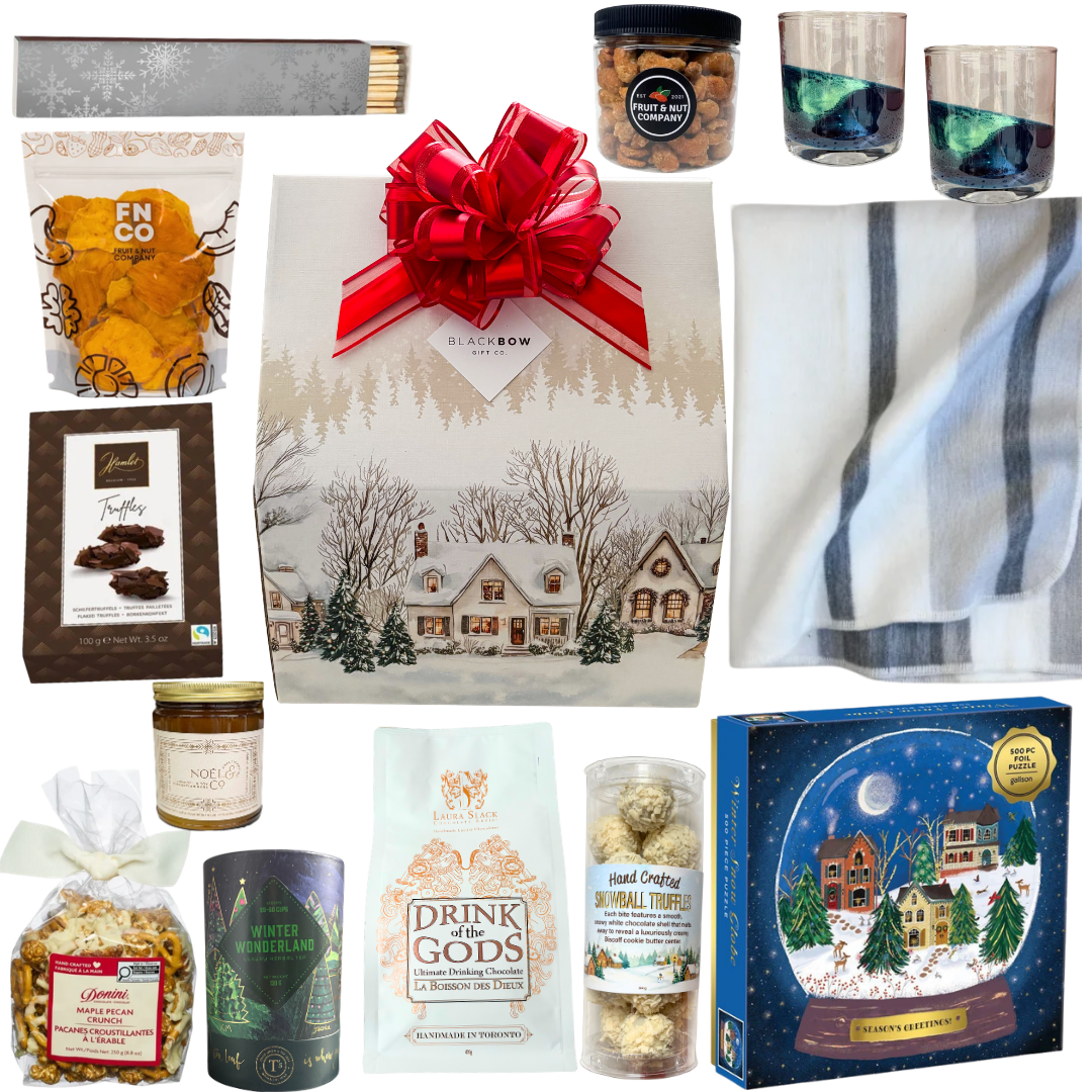 The Winter Escape luxury gift featuring a cozy blanket, elegant drinkware, gourmet chocolates, hot chocolate and artisan treats in a beautifully illustrated winter village gift package.