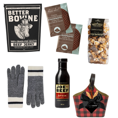 The Winter Explorer gift basket featuring a red and black buffalo plaid keepsake caddy filled with gourmet snacks, winter accessories and cozy wool gloves with an optional sock selection.