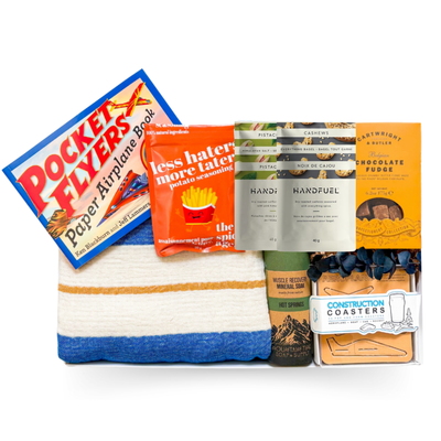 The Good Stuff large gift box with Turkish throw, build-your-own pocket planes, construction coasters, gourmet treats and muscle soak by Black Bow Gift Co.