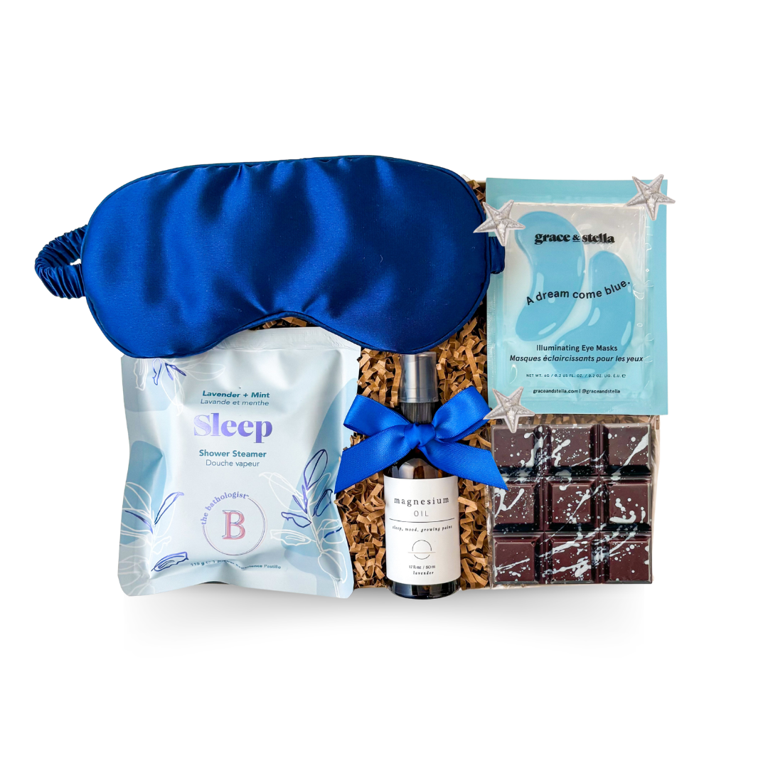 The Sleep Kit Gift Box with star accents, navy satin sleep mask, and wellness essentials styled in soft blue and white for a dreamy, restful theme.