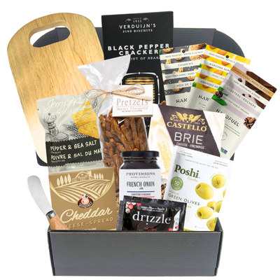 The Perfect Spread charcuterie gift box with wood serving board, cheese knife, brie, crackers, cheese spread, jam, olives and gourmet snacks