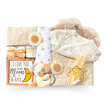 Luxury baby gift box featuring cozy newborn essentials, soft keepsakes, comforting textures, indulgent treats, and thoughtful details for baby and parents, beautifully presented in an XL keepsake box designed to celebrate meaningful first moments.