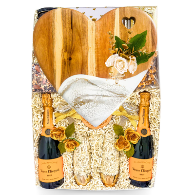 Luxury champagne gift box featuring Veuve Clicquot, champagne flutes, gourmet treats, romantic accents, and XL keepsake presentation by Black Bow Gift Co.