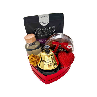 Valentine’s gift in a red heart box with self-care and sweet treats, wrapped in clear cellophane and styled for romantic gifting.