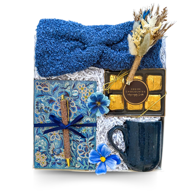 Warm Thoughts cozy gift box with soft blue headband, journal and pen, textured mug, chocolates and a choice of gourmet hot chocolate or tea, thoughtfully packaged by Black Bow Gift Co.
