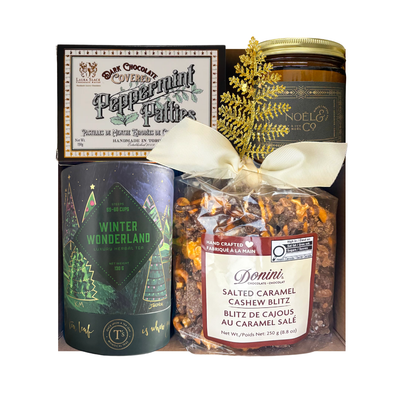Winter Indulgence holiday gift box with luxury herbal tea, peppermint chocolates, salted caramel cashew treats, a festive candle and a choice of holiday puzzle.