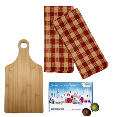 Winter Board holiday gift with wooden board, bow-tied tea towels, snowflake ornament, and festive chocolates.
