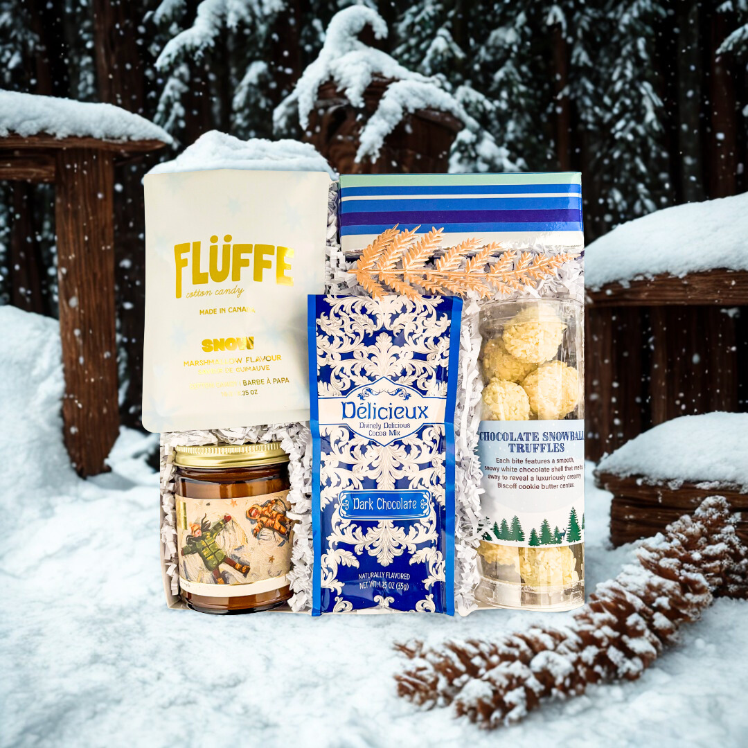 Flüffe chocolate products in the snow with a wooden bench and snow-covered trees in the background.