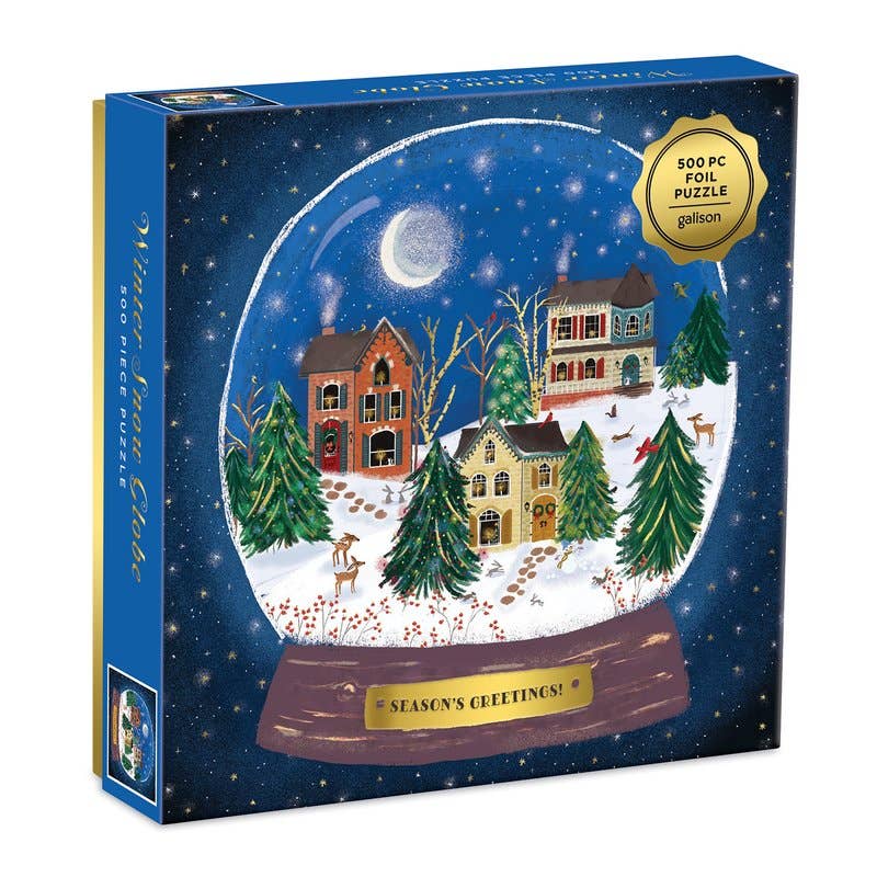 500-piece winter snow globe puzzle featuring a snowy village, festive trees, deer, cardinals, and foil accents.